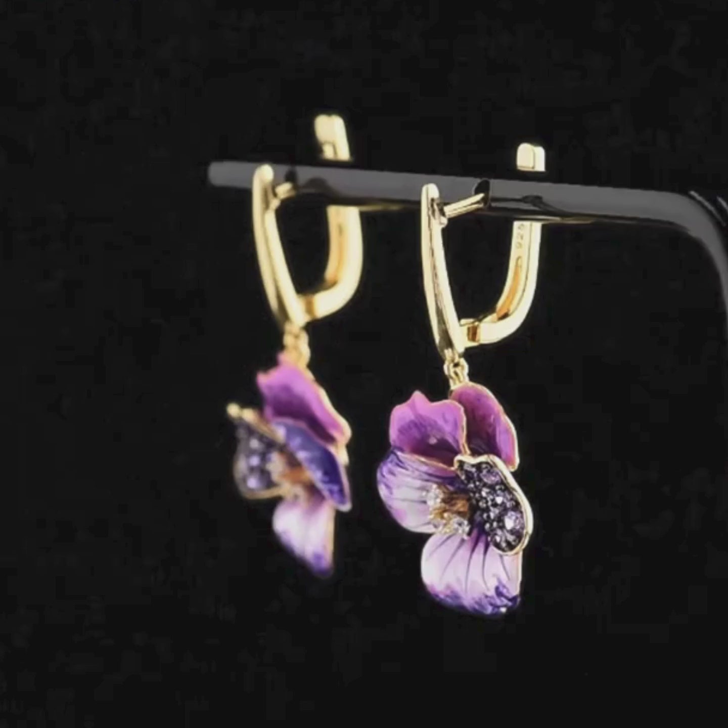Gold-plated earrings with purple enamel pansy flowers and pavé gemstone detailing

